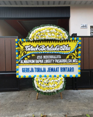Papan Bunga Duka di Giring